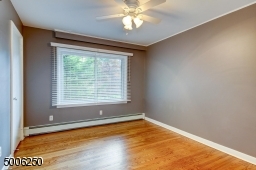 Bright, 2nd Bedroom features a wood floor, newer window, closet, ceiling fan.