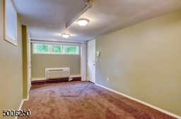 The lower level offers additional living space with cozy Family Room - wall-to-wall carpeting - wall unit for heating/air.
