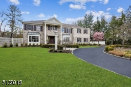 Stunning setting with circular driveway and professionally landscaped property.