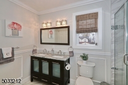 There is a double vanity, large stall shower & linen closet.