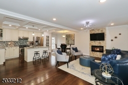 Gleaming hardwood floors , recessed lighting, box beam ceiling and electric fireplace with heat fan.