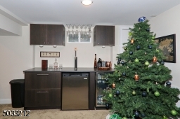 Bar with wine refrigerator, kegerator and storage drawers.