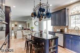Center Island with Granite Counters & Decorative Pot Rack