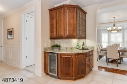 Butler's Pantry area is convenient to Dining Room -- includes beverage refrigerator -- great for serving pieces when entertaining; not shown, a large, walk-in Pantry is nearby in the Kitchen
