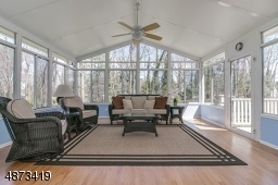 French doors lead to this Four Seasons sun room.   Floor-to-ceiling views on 3 sides; this room has its own separate heating/cooling, as well as ceiling fan..  Overlooks backyard -- access to deck
