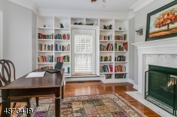 Den/Libarry/Home Office -- tucked into a quiet corner of the 1st floor; gas fireplace, floor-to-ceiling built-ins; door for quiet reading or work.