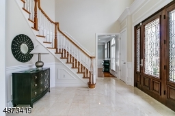 Generous-sized, gracious entryway; beautiful mahogany door; marble floor; home also has a secondary staircase to 2nd floor