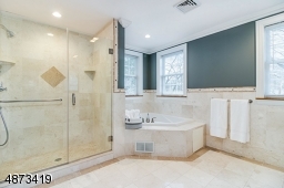 In addition to a jetted tub, this master bath has an oversized walk-in shower.
