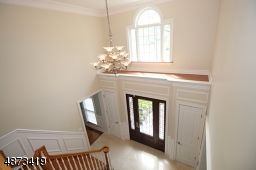 2-story entry; chandelier has 'lift system' for easy cleaning, bulb replacement; shown are 2 of the 3 coat closets in the entry area
