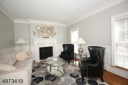 Beautiful millwork and hardwood floors enhance this elegant Living Room; gas fireplace; freshly painted