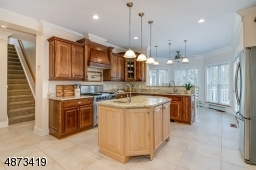 This view of the Kitchen shows the secondary staircase to the 2nd floor