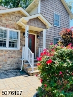 Beautiful Flowers surround entry way to Front Door