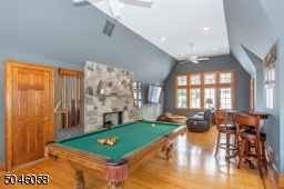 A separate full staircase leads to second floor entertainment area, that features an architectural window, a stone fireplace and vaulted ceilings. A perfect area for a play space, billiard or media room! The possibilities are endless!