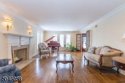 Soothing neutral colors and pristine hardwood floors enhance the natural light that radiates through oversize architectural windows, creating a warm and inviting feeling.
