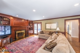 Enjoy relaxing by the roaring fire while watching your favorite classic in this beautifully detailed room with built in cabinetry and large expanses of glass window.