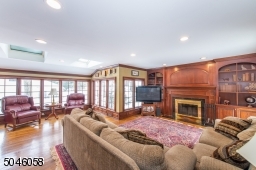 Enjoy relaxing by the roaring fire while watching your favorite classic in this beautifully detailed room with built in cabinetry and large expanses of glass window.