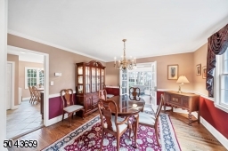 The dining room is next to the kitchen. There are glass French doors to the three season sunroom.