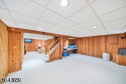 The lower level has 2 spaces with wood walls and a new carpet. There is a laundry utility room. The furnace and AC are new in 2020.