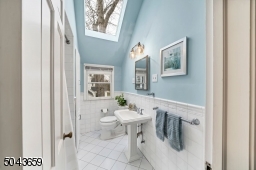 The main hall bath has a tub shower, linen closet and skylight.