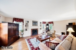 The front to back living room is sunny and bright throughout the day. There is a wood burning fireplace flanked by built-ins.
