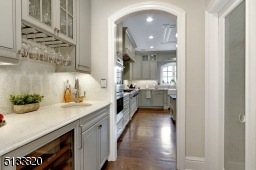 Bar sink, wine refrigerator, wine glass rack and large walk-in pantry closet