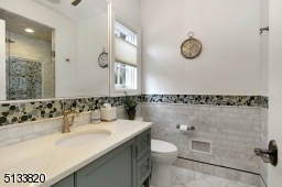 This bathroom has a stall shower with built-in bench