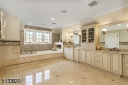 Features include: BainUltra Jacuzzi, radiant heated floor, towel warmer & custom vanity with double sinks
