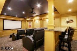 110? screen with Epson ceiling mounted projector. Enhanced acoustics for the ultimate surround sound experience. Eight leather reclining chairs