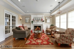 Overlooks front yard with gas fireplace, ribbon trim hardwood floors, beveled glass French doors, tray ceiling with rope lighting, speakers
