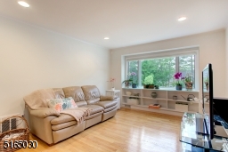 Large picture window overlooks fenced back yard.