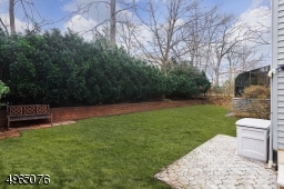 Beautiful Backyard with Flower Planting Bed & Evergreen Trees!