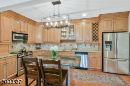 Updated with new cabinetry, stainless steel appliances, granite countertops, open to the living room