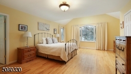 Primary bedroom suite with cathedral ceilings, recessed lighting, two walk-in closets
