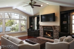 Family Room addition with wood burning fireplace, open to the gourmet Kitchen with outside access.