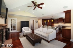 Family Room addition with wood burning fireplace, open to the gourmet Kitchen with outside access.