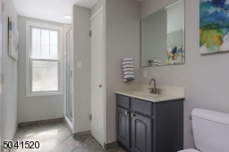 Full bath with stall shower in the finished, walk-out ground level.
