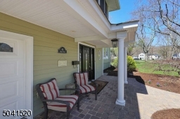 A beautiful paver patio wraps around the home.