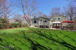 Professionally landscaped property with a putting green, storage shed, patio and new gazebo.