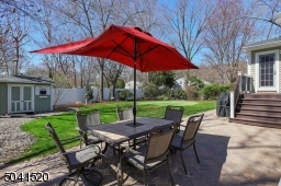 Professionally landscaped property with a putting green, storage shed, patio and new gazebo.