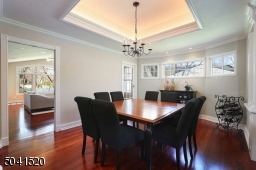 Dining Room with tray ceiling and decorative moldings.