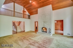 This amazing fireplace is 2-sided and look at that hallway to the 2nd floor!